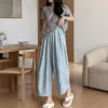 A casual summer look for women with light blue loose trousers paired with a grey top details Picture